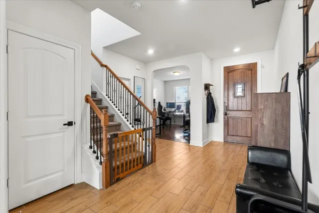 a view of a hallway with wooden floor and staircase
