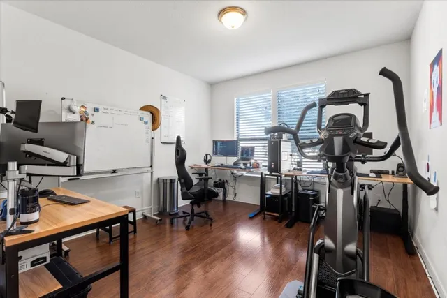 a view of a workspace with furniture and a gate