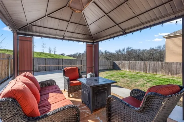 a view of a house with backyard sitting area and garden