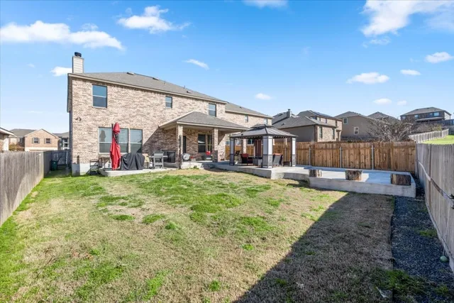 a view of a house with yard and sitting area