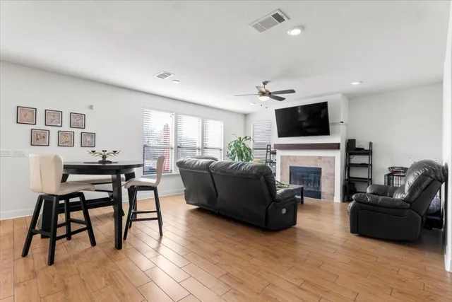 a living room with furniture a fireplace and a flat screen tv