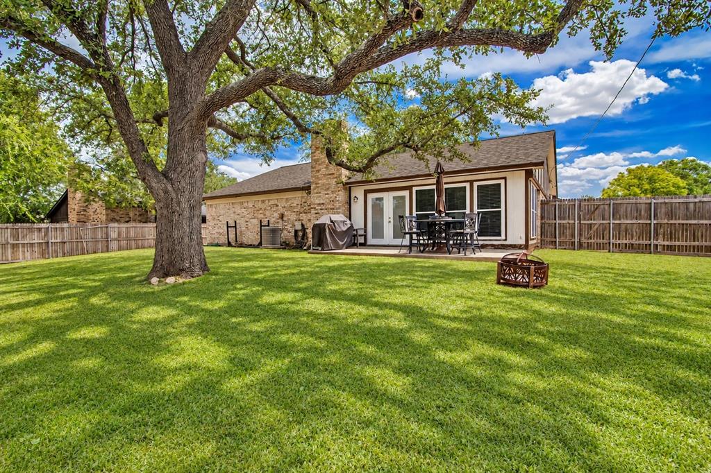 3824 Sugar Ridge Road Fort Worth, TX 76133 - Photo 19 of 29 Well cared for backyard with a large mature oak tree.