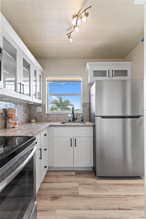 2720 North Pine Island Road, Unit 307 Sunrise, FL 33322 - Photo 11 of 40 a kitchen with sink cabinets and stainless steel appliances