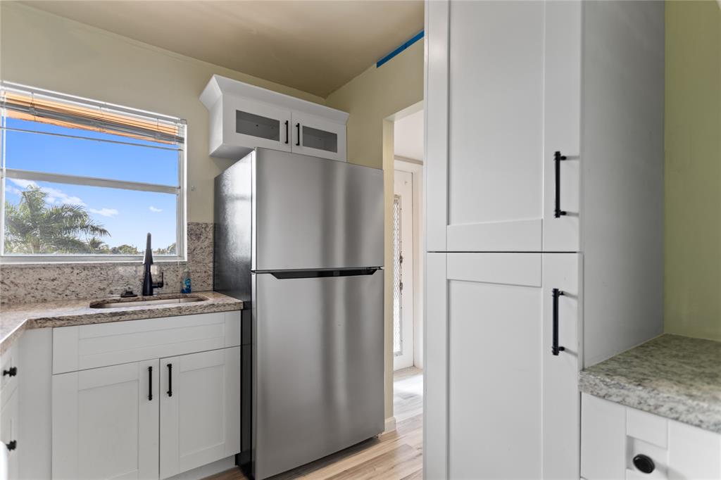 2720 North Pine Island Road, Unit 307 Sunrise, FL 33322 - Photo 12 of 40 a white refrigerator freezer sitting inside of a kitchen