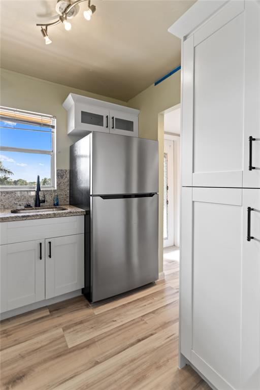 2720 North Pine Island Road, Unit 307 Sunrise, FL 33322 - Photo 13 of 40 a kitchen with a refrigerator a stove top oven and cabinets