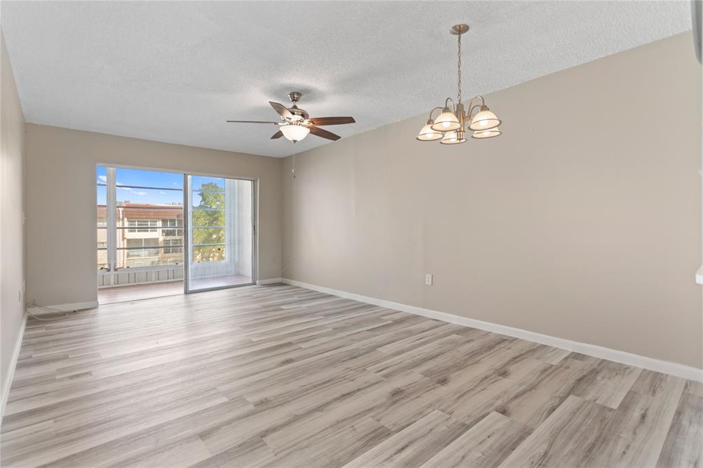 2720 North Pine Island Road, Unit 307 Sunrise, FL 33322 - Photo 17 of 40 a view of empty room with wooden floor and fan