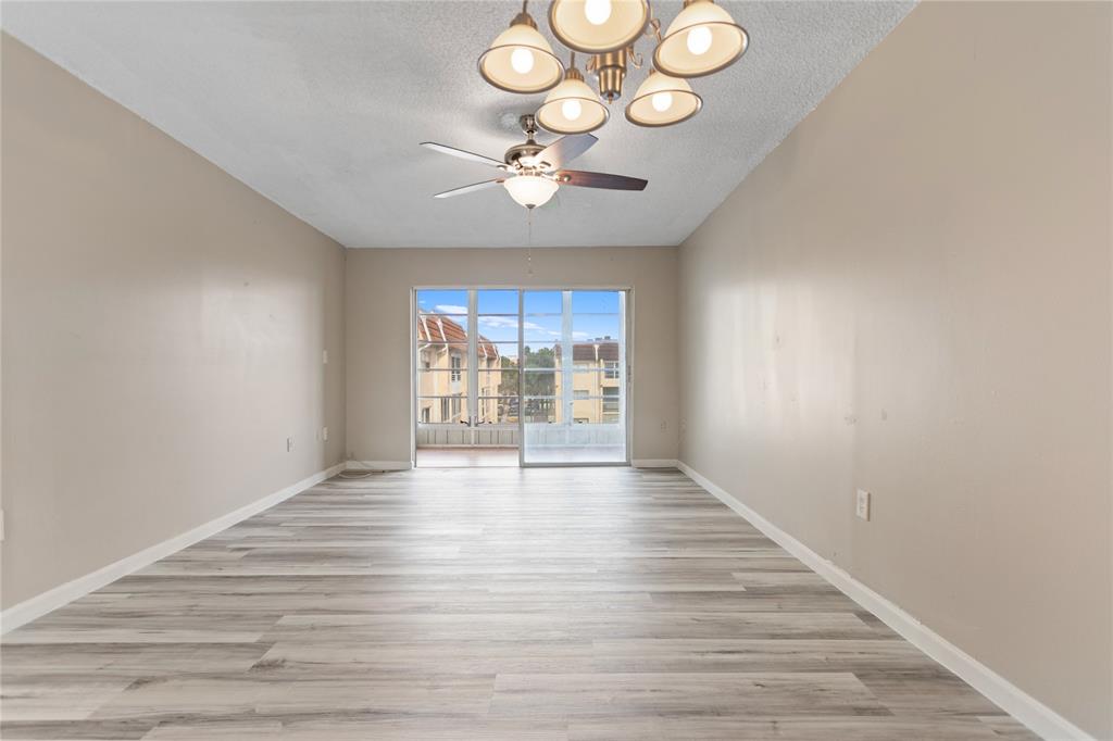 2720 North Pine Island Road, Unit 307 Sunrise, FL 33322 - Photo 19 of 40 a view of an empty room with wooden floor and a window