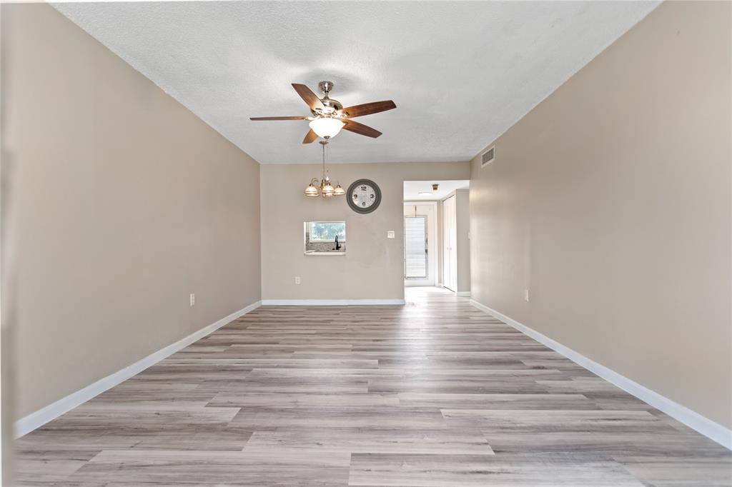 2720 North Pine Island Road, Unit 307 Sunrise, FL 33322 - Photo 20 of 40 a view of an empty room with wooden floor and a window