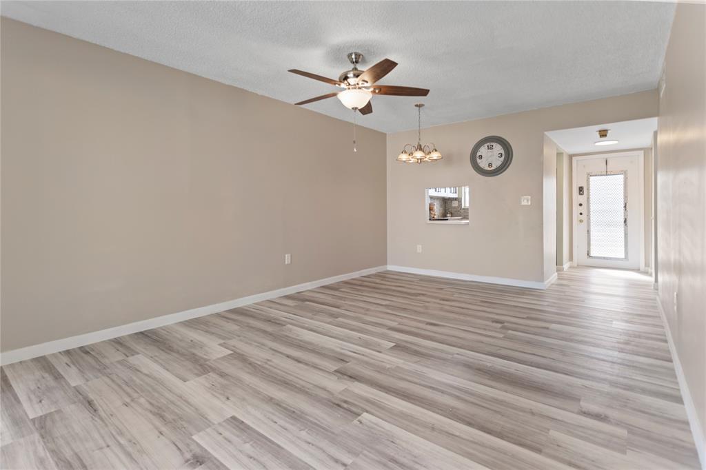 2720 North Pine Island Road, Unit 307 Sunrise, FL 33322 - Photo 21 of 40 a view of a livingroom with wooden floor and a ceiling fan