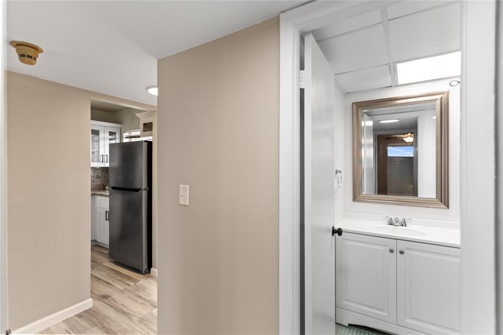 2720 North Pine Island Road, Unit 307 Sunrise, FL 33322 - Photo 29 of 40 a bathroom with a sink a light fixture and a mirror