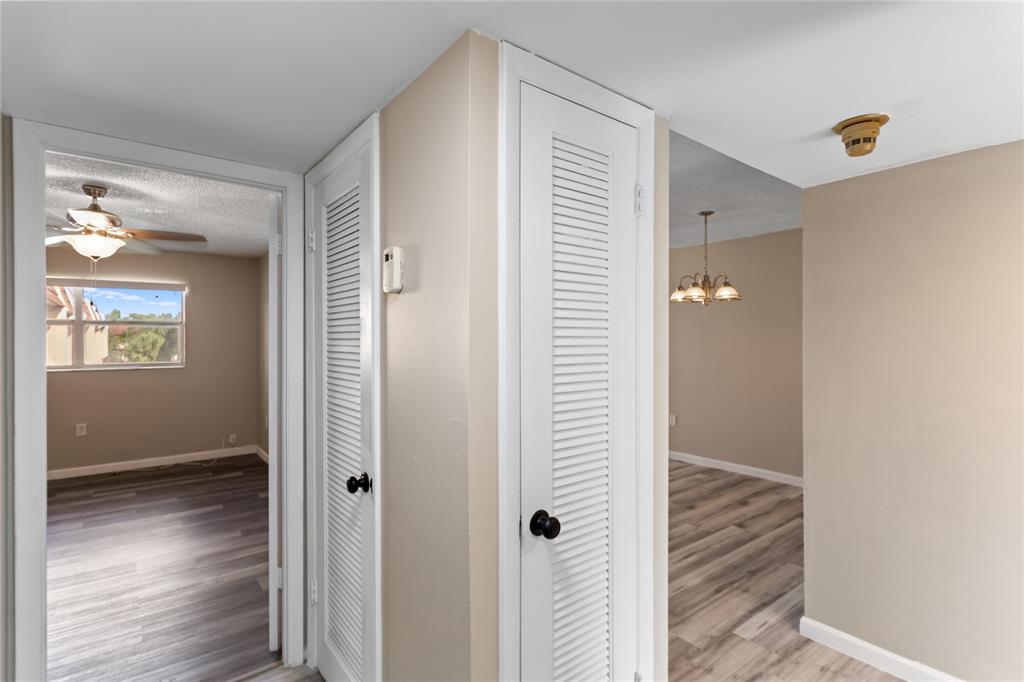 2720 North Pine Island Road, Unit 307 Sunrise, FL 33322 - Photo 33 of 40 a view of a hallway with wooden floor and closet area