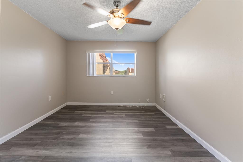 2720 North Pine Island Road, Unit 307 Sunrise, FL 33322 - Photo 34 of 40 wooden floor in an empty room with a window