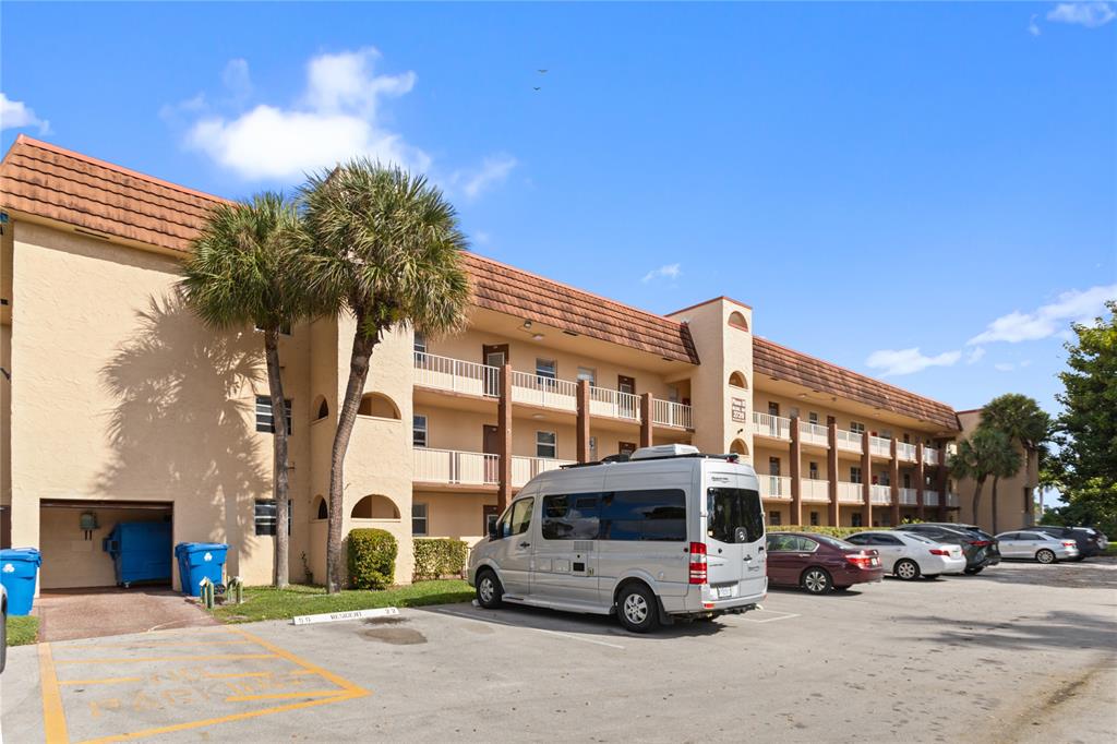 2720 North Pine Island Road, Unit 307 Sunrise, FL 33322 - Photo 4 of 40 a car parked in front of a building