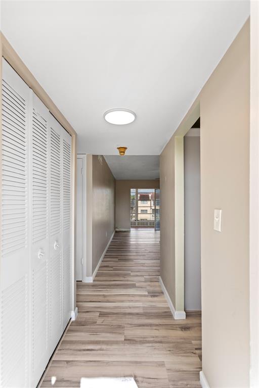 2720 North Pine Island Road, Unit 307 Sunrise, FL 33322 - Photo 8 of 40 a view of a hallway with wooden floor and staircase