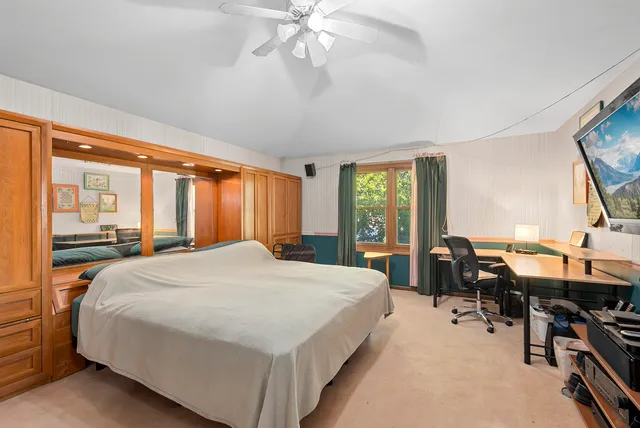 a bed room with a bed and a large window