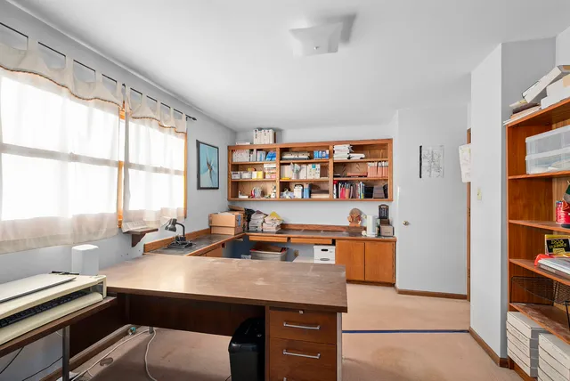 a room with a large window and book shelf