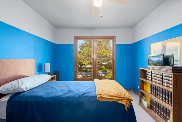 a bed sitting in a bedroom next to a window