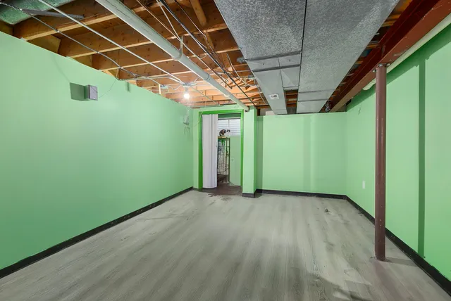 a view of a room with wooden floor and windows