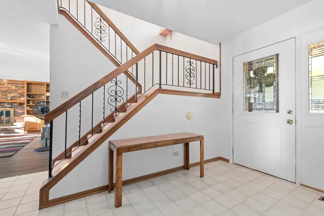 a view of staircase with white walls and a window