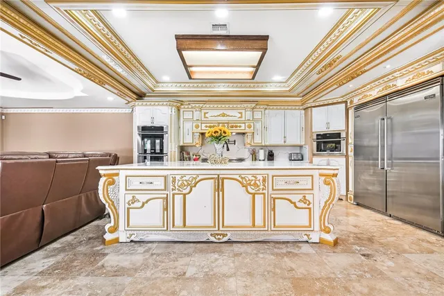 a kitchen with stainless steel appliances kitchen island granite countertop a sink and cabinets