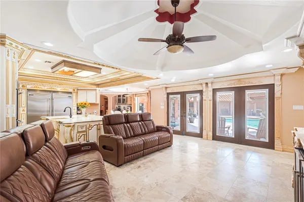a living room with furniture and a chandelier