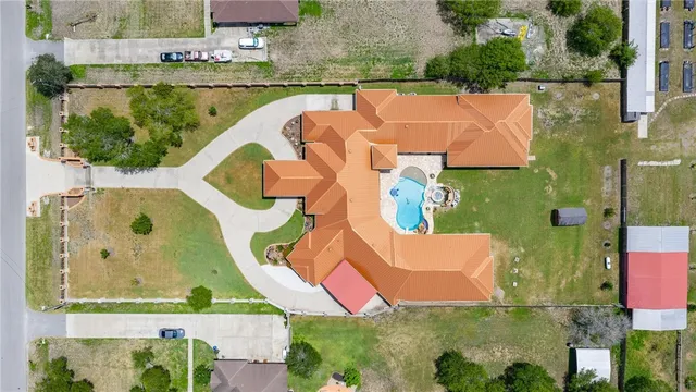 an aerial view of residential house with outdoor space and swimming pool