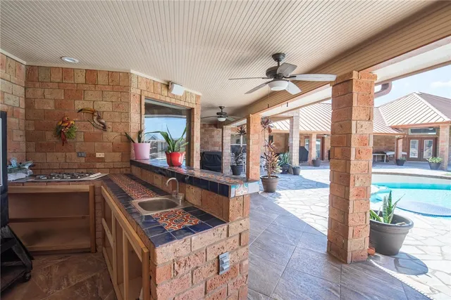 a patio with a table and chairs under an umbrella