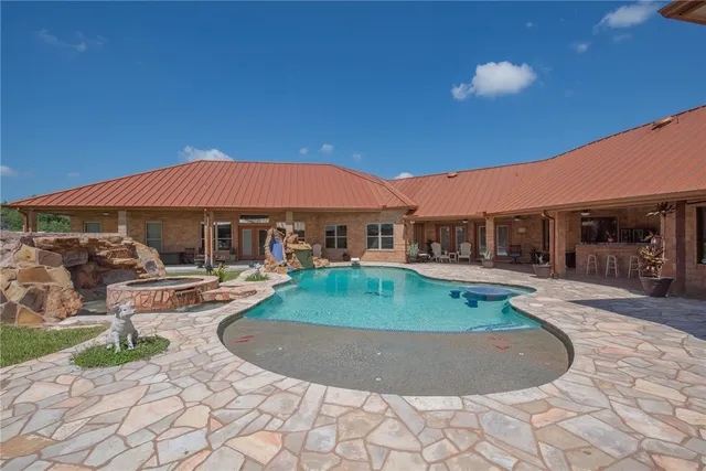 a view of a patio with swimming pool table and chairs