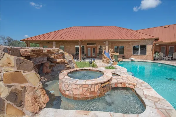 an aerial view of residential houses with outdoor space and trees