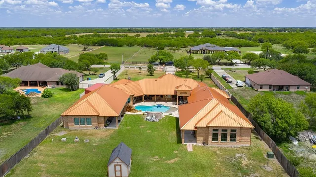 an aerial view of a house a yard and outdoor seating