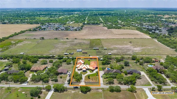 an aerial view of a house with garden space and outdoor seating