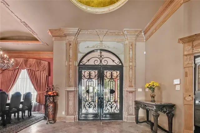 a living room with fireplace furniture and a chandelier