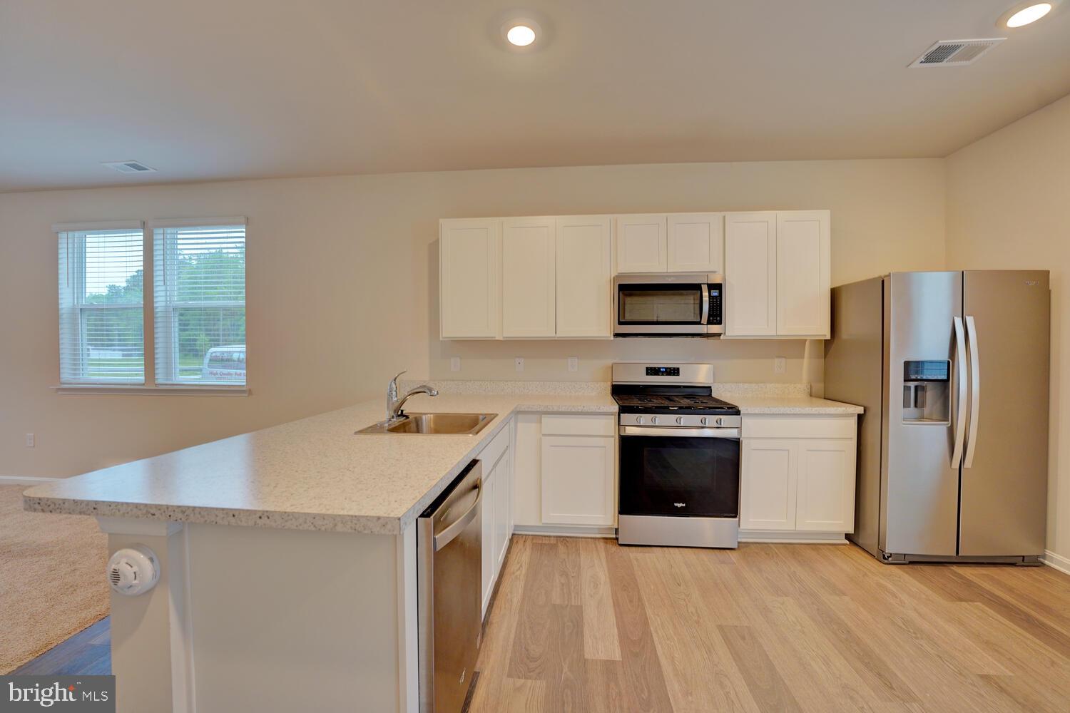 21 Crowberry Drive Magnolia, DE 19962 - Photo 15 of 38 a kitchen with a stove a refrigerator and a sink