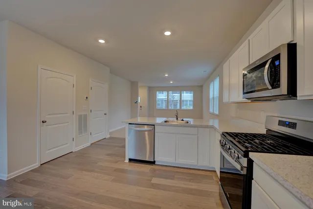 a kitchen with cabinets and stove