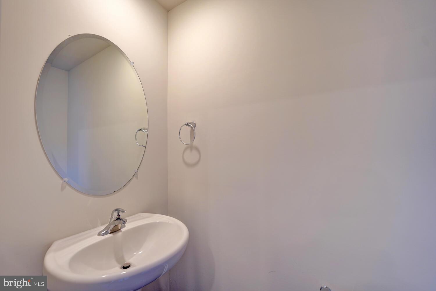 21 Crowberry Drive Magnolia, DE 19962 - Photo 36 of 38 a bathroom with a sink and a mirror