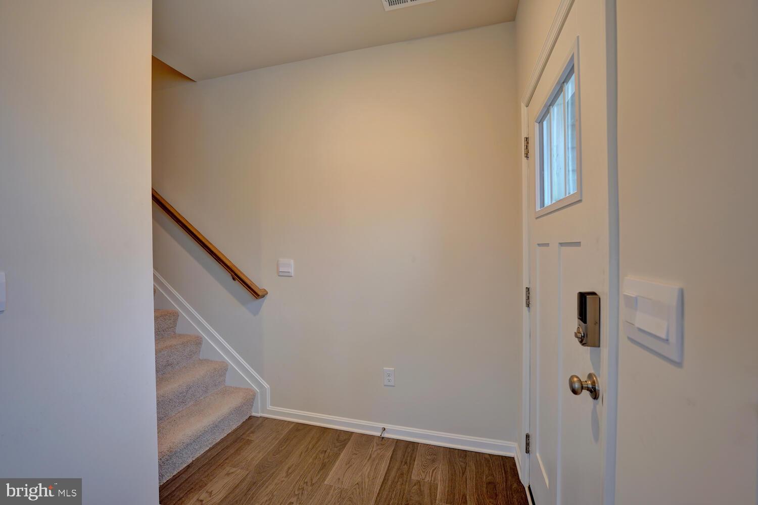 21 Crowberry Drive Magnolia, DE 19962 - Photo 5 of 38 a view of staircase with wooden floor and white walls