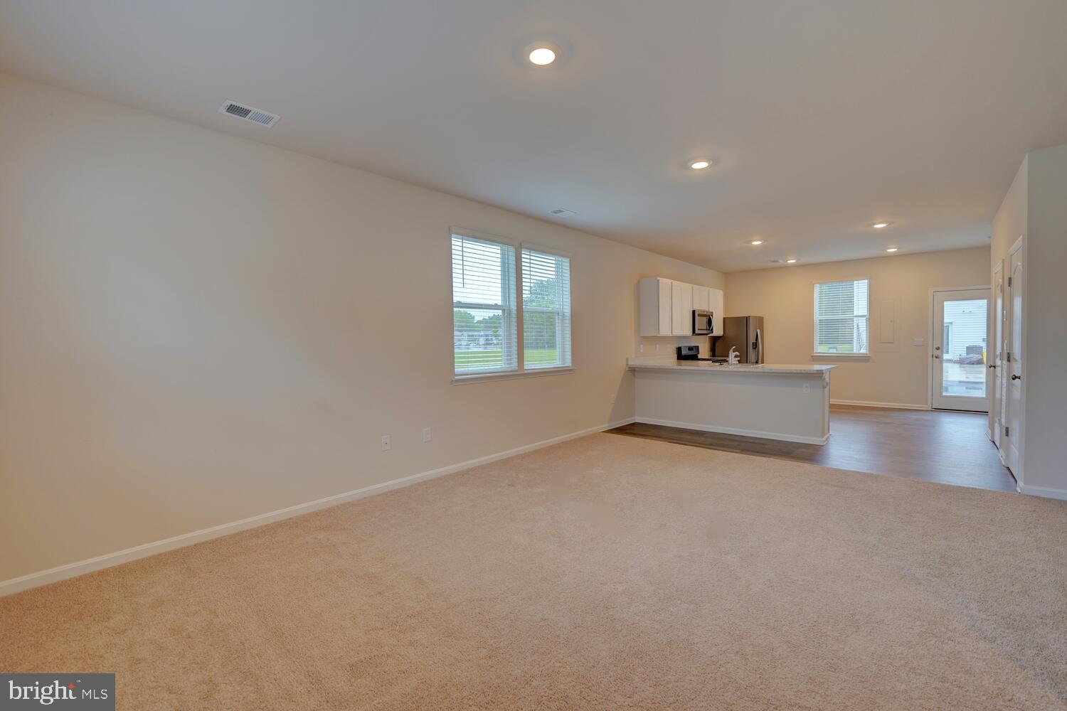 21 Crowberry Drive Magnolia, DE 19962 - Photo 7 of 38 a view of an empty room with a window and wooden floor