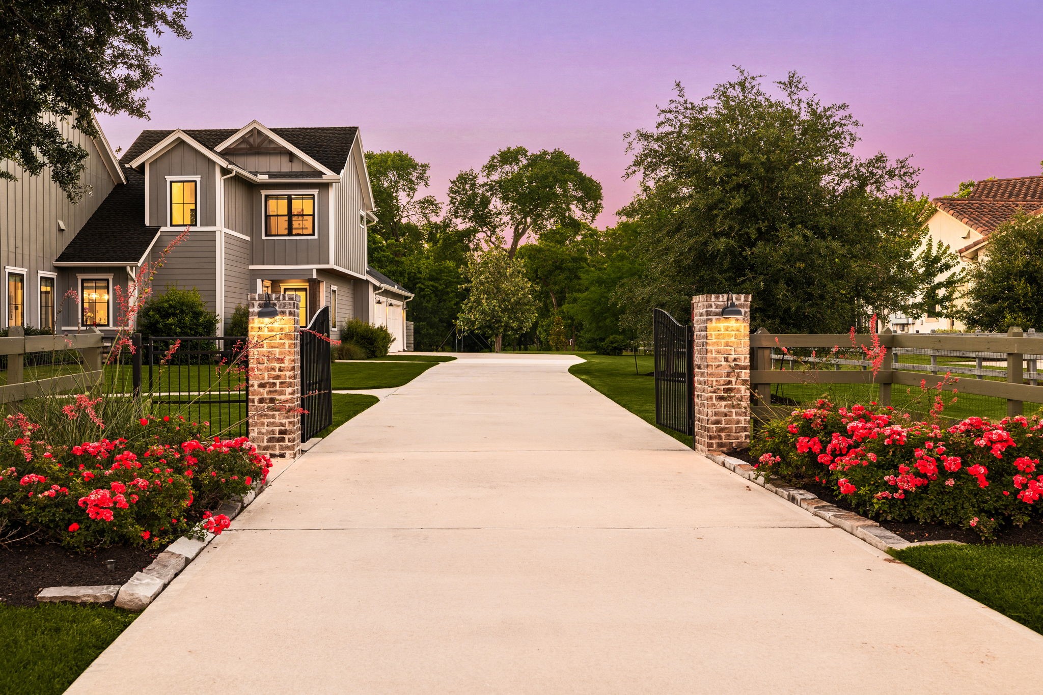4311 Upper Oxbow Trace Fulshear, TX 77441 - Photo 4 of 49 Private gated driveway with elegant landscaping and a grand entrance.