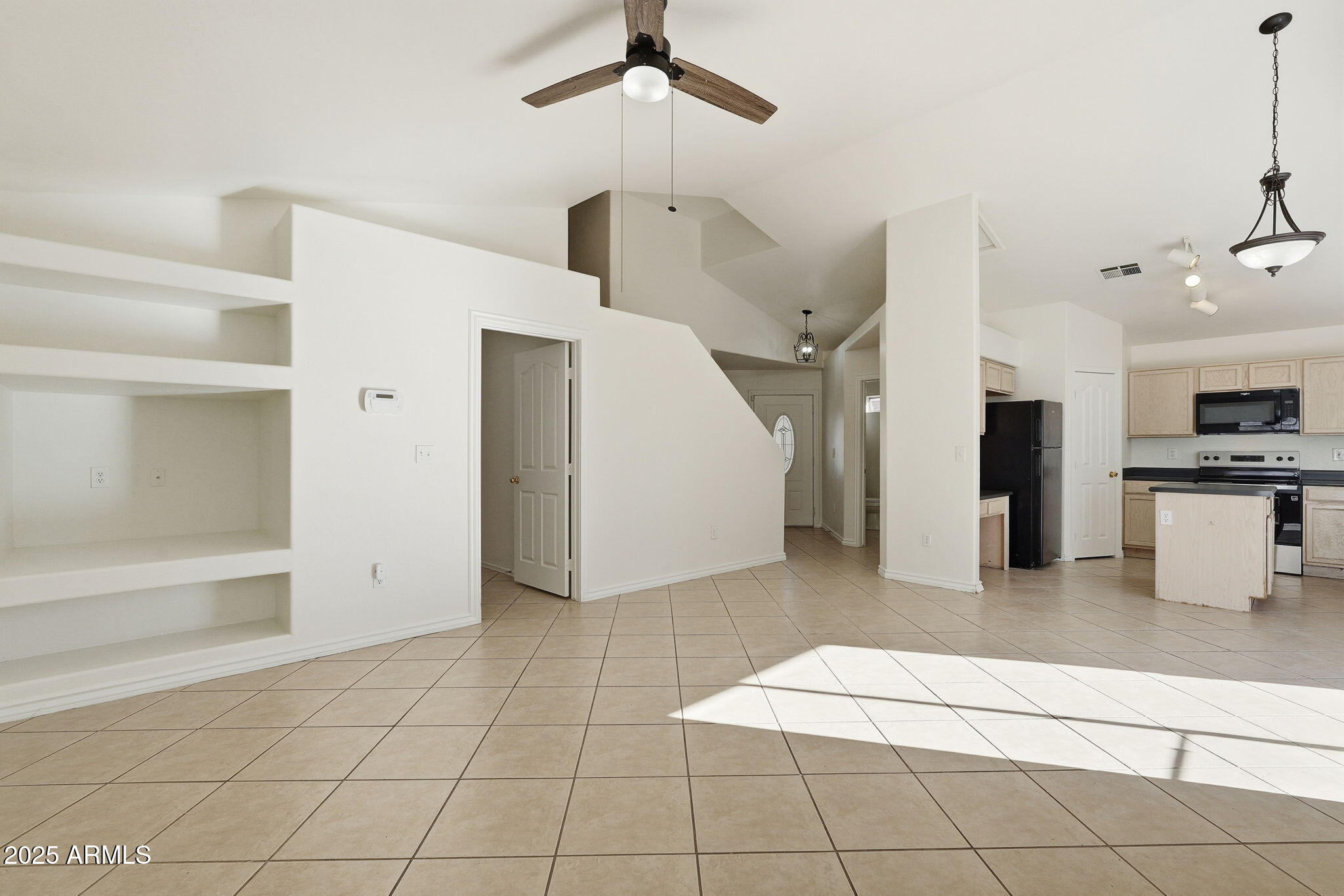 2061 East Appaloosa Road Gilbert, AZ 85296 - Photo 10 of 37 a living room with stainless steel appliances kitchen island granite countertop a refrigerator and a sink