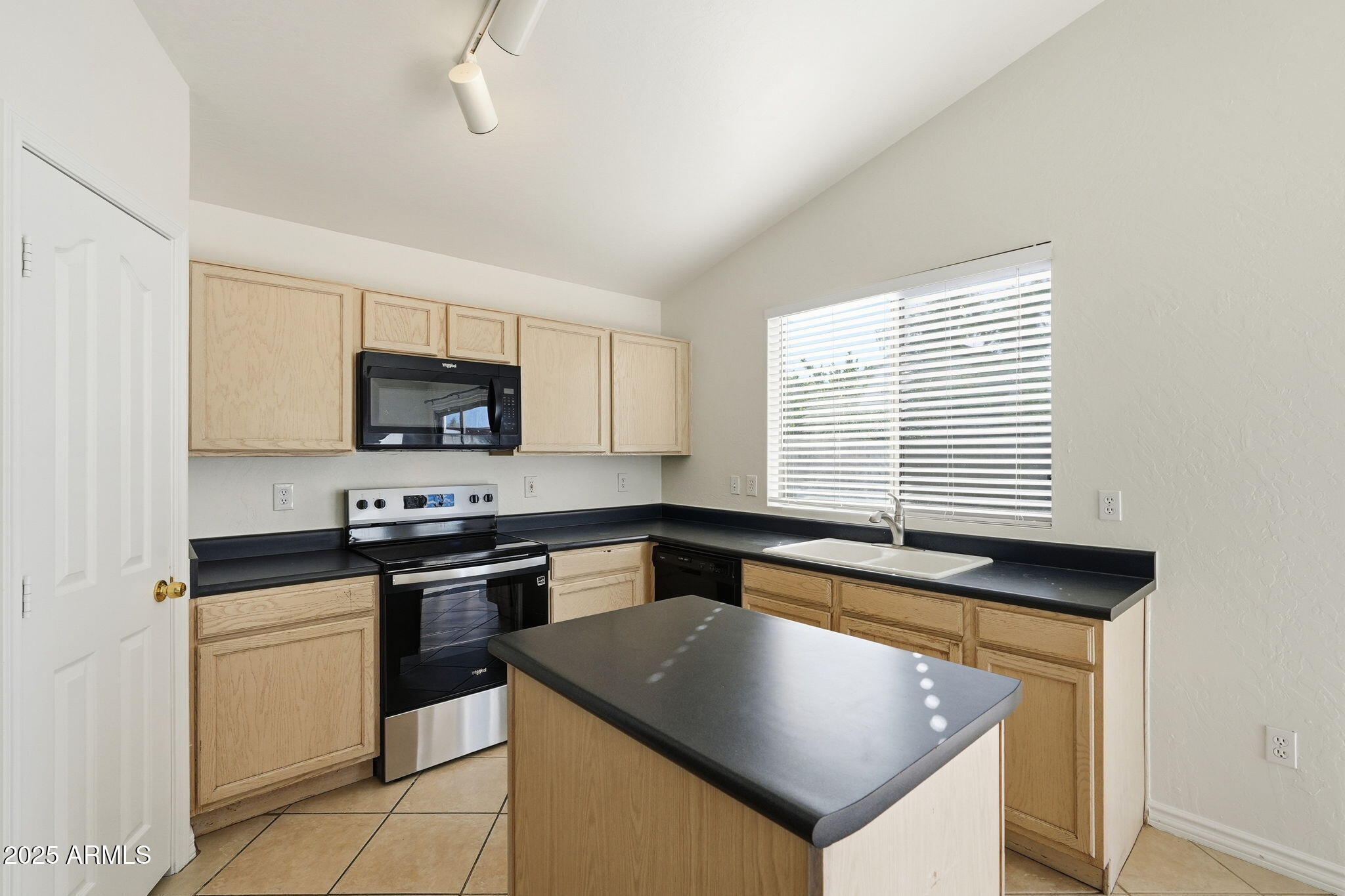 2061 East Appaloosa Road Gilbert, AZ 85296 - Photo 11 of 37 a kitchen with stainless steel appliances granite countertop a sink stove and microwave