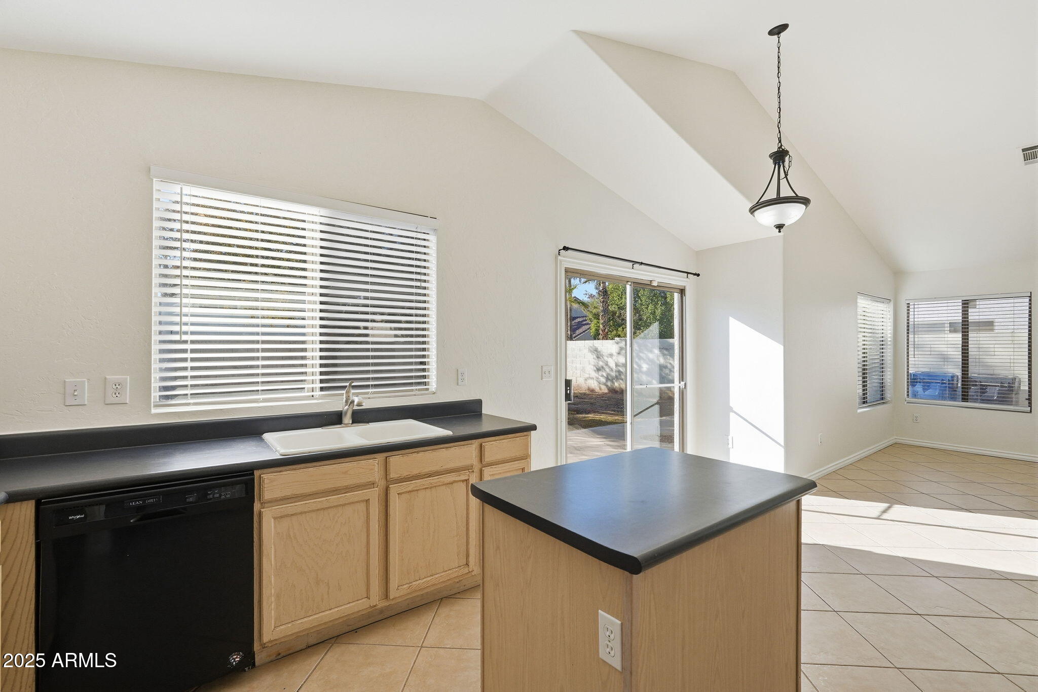 2061 East Appaloosa Road Gilbert, AZ 85296 - Photo 14 of 37 a kitchen with granite countertop kitchen island a sink stainless steel appliances and cabinets