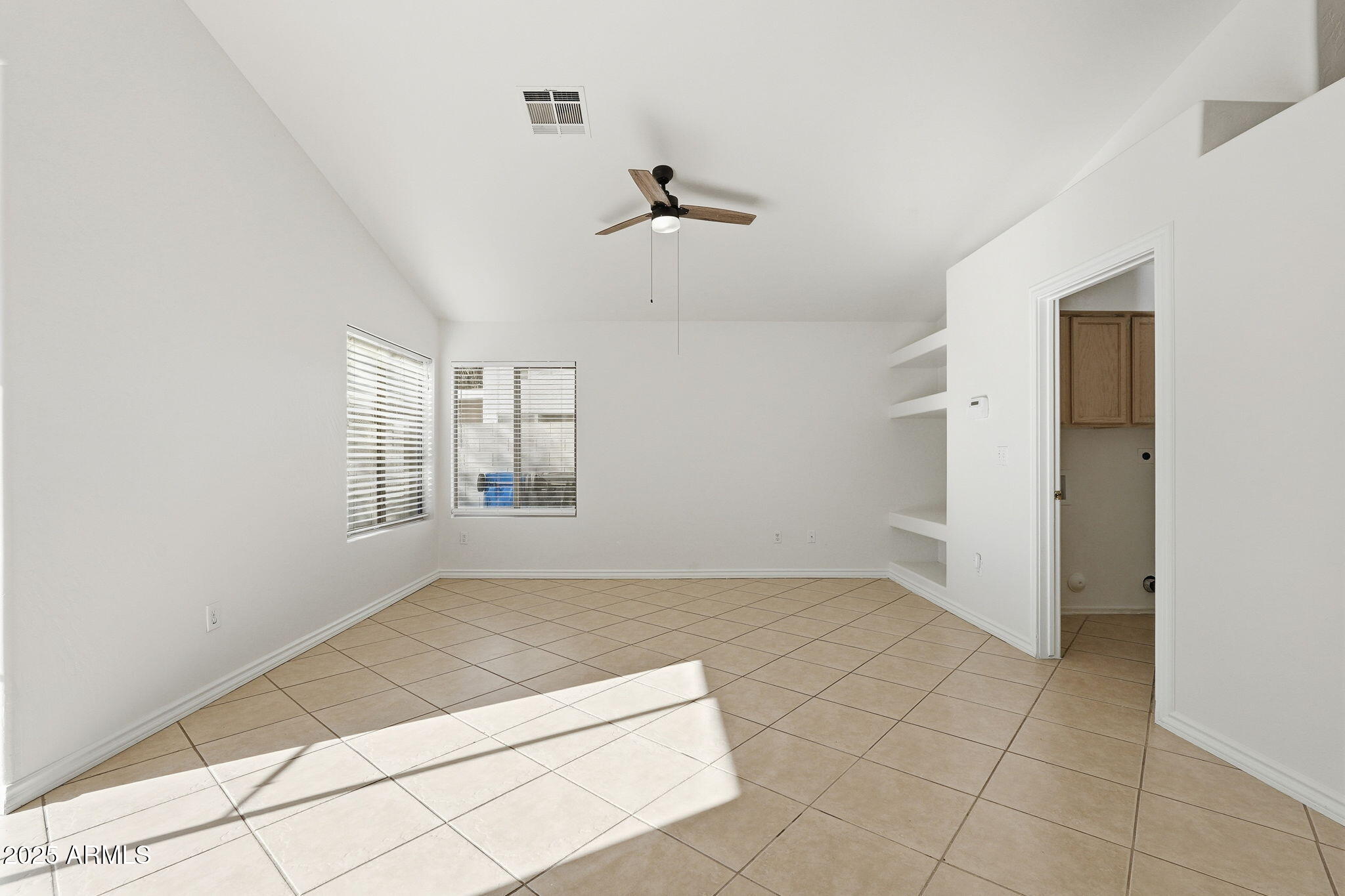 2061 East Appaloosa Road Gilbert, AZ 85296 - Photo 17 of 37 an empty room with windows and ceiling fan