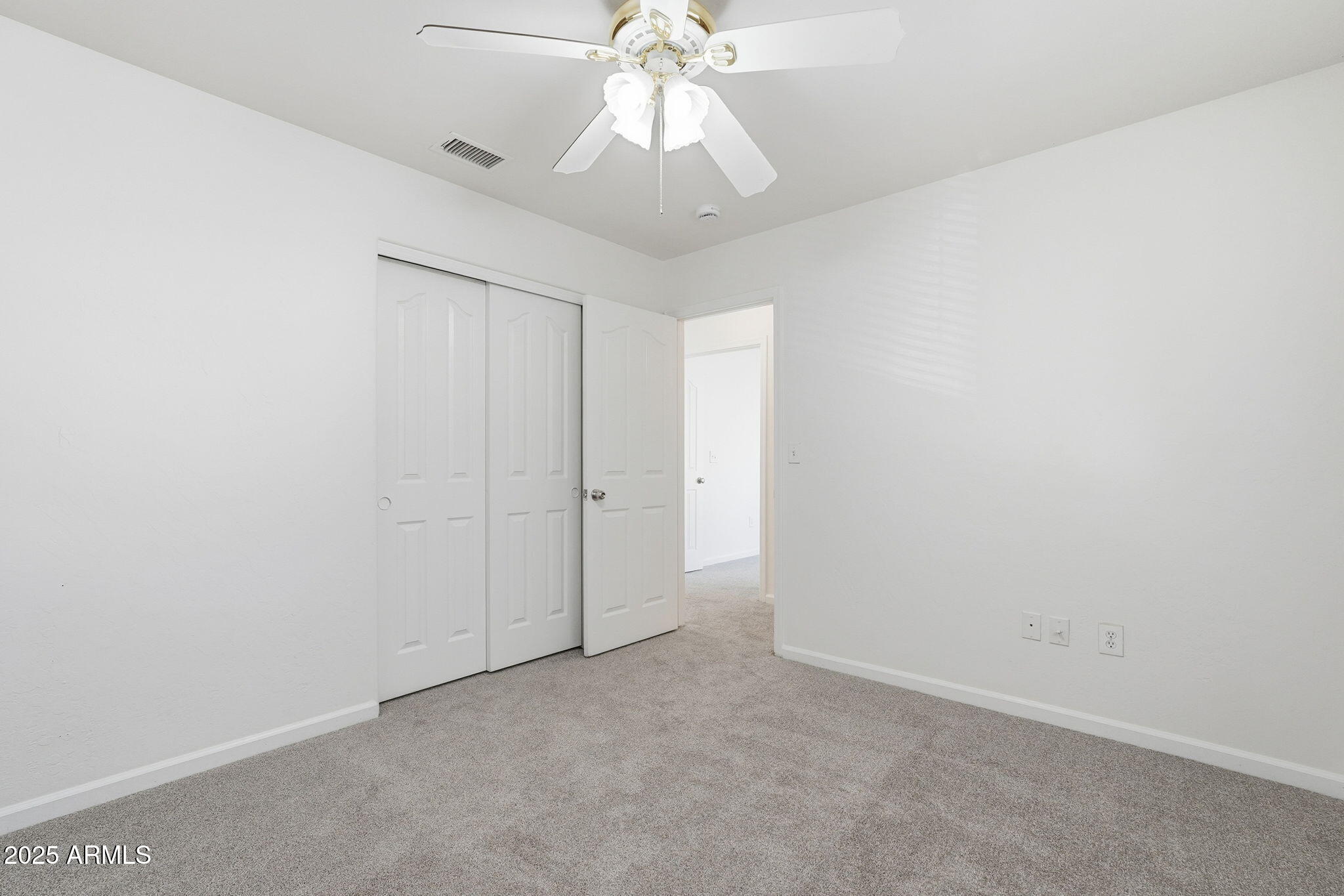 2061 East Appaloosa Road Gilbert, AZ 85296 - Photo 20 of 37 an empty room with a chandelier fan and windows