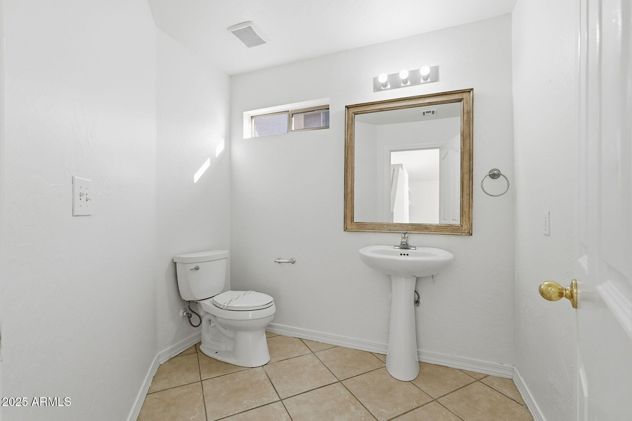 2061 East Appaloosa Road Gilbert, AZ 85296 - Photo 25 of 37 a bathroom with a toilet sink and mirror