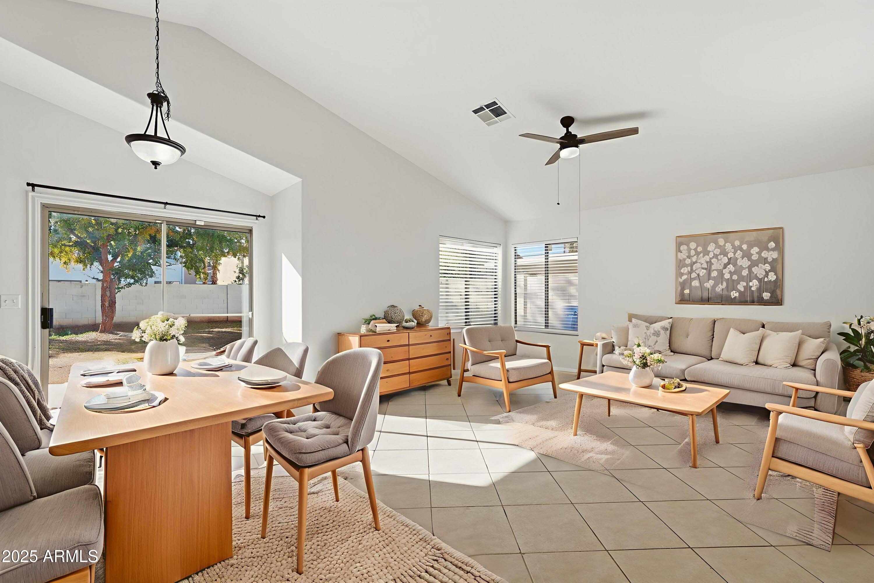 2061 East Appaloosa Road Gilbert, AZ 85296 - Photo 3 of 37 a living room with furniture a flat screen tv and a window
