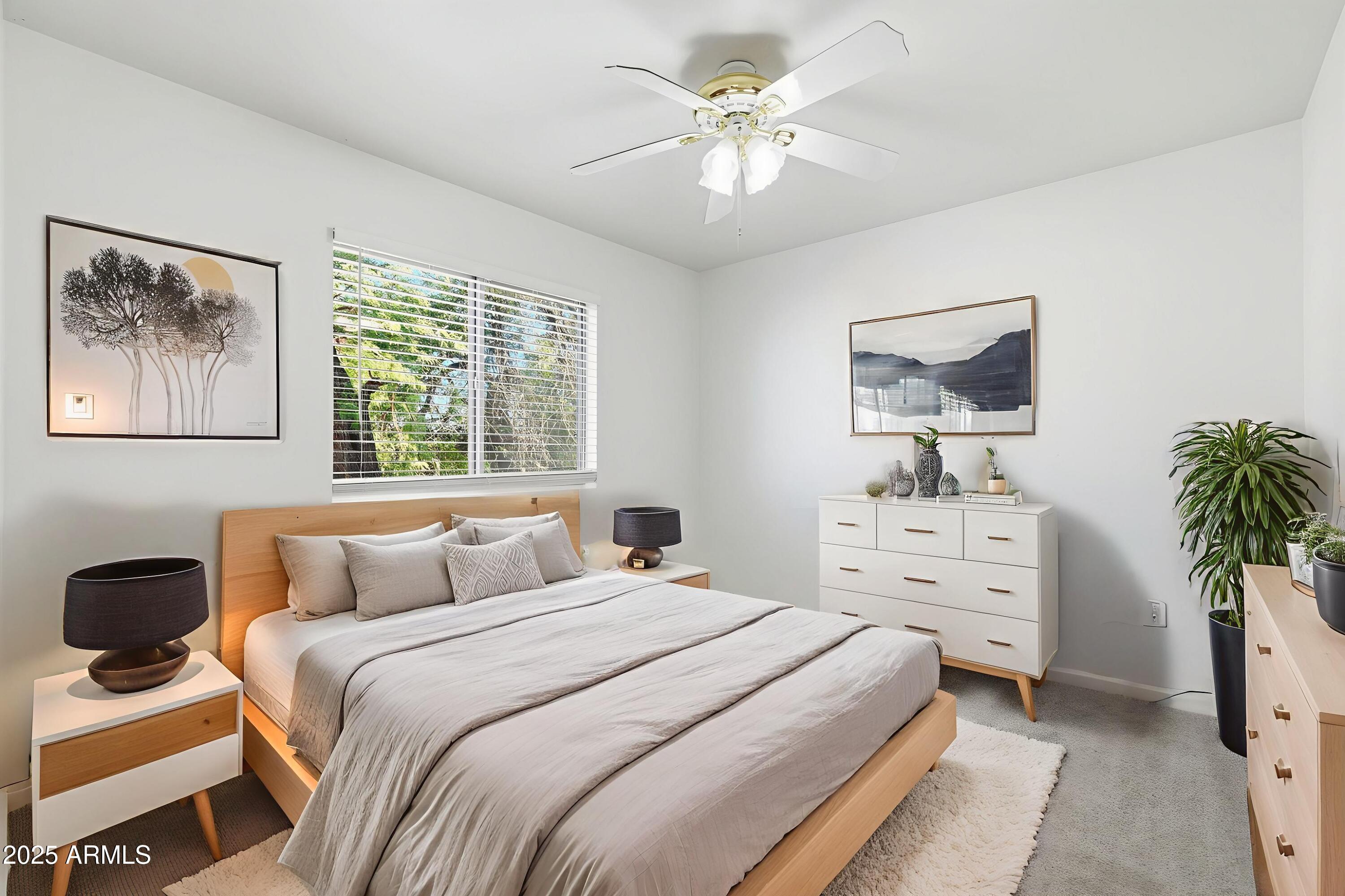 2061 East Appaloosa Road Gilbert, AZ 85296 - Photo 5 of 37 a bedroom with a bed and a chandelier