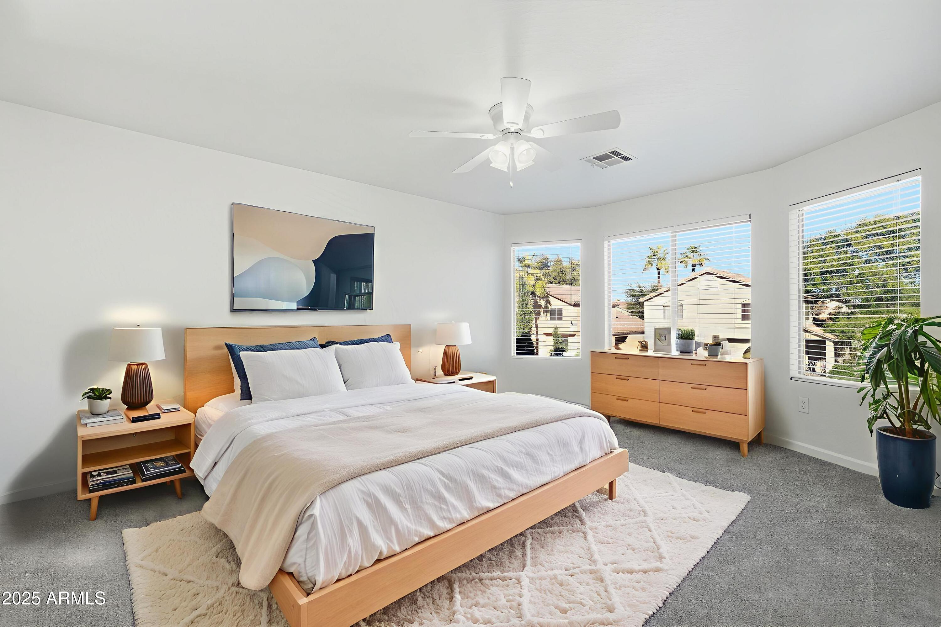 2061 East Appaloosa Road Gilbert, AZ 85296 - Photo 7 of 37 a bedroom with a bed and ceiling fan