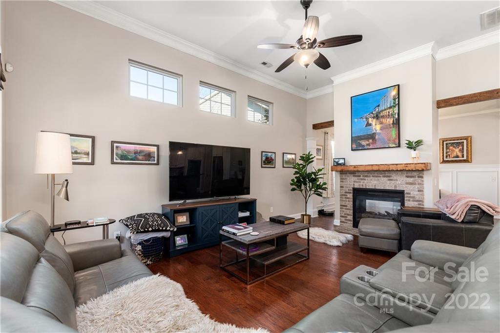 1235 Gold Rush Court Fort Mill, SC 29708 - Photo 13 of 42 a living room with furniture a fireplace and a flat screen tv