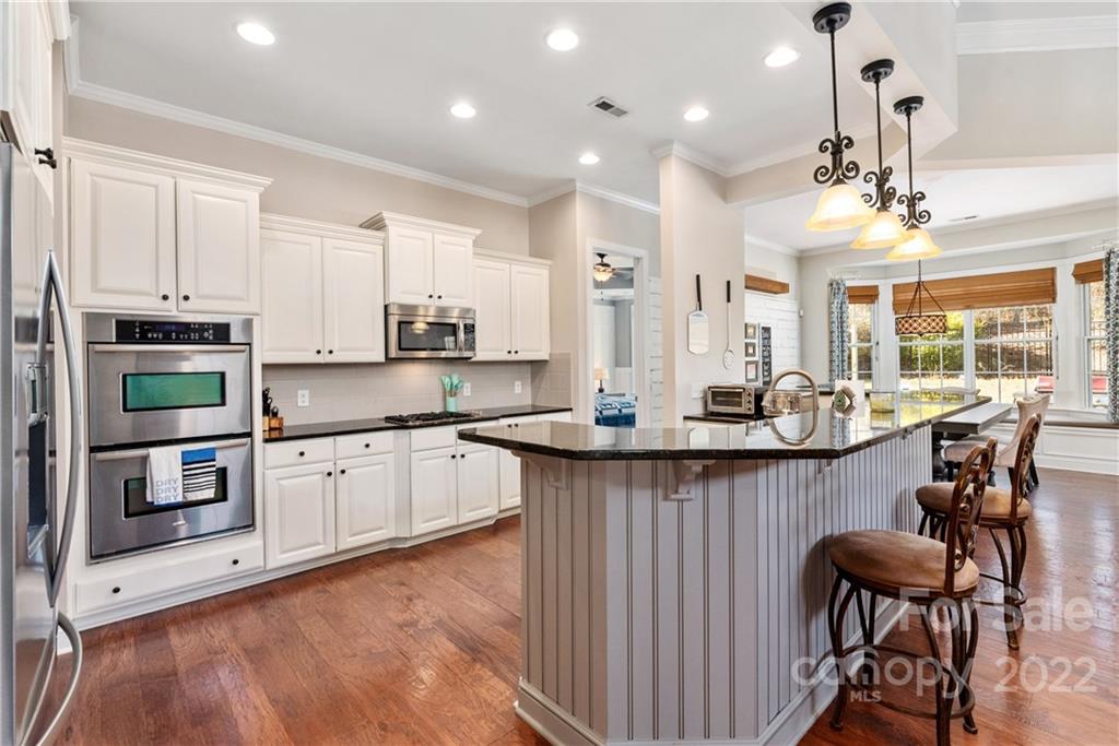 1235 Gold Rush Court Fort Mill, SC 29708 - Photo 15 of 42 a kitchen with stainless steel appliances a sink a stove a refrigerator cabinets and chairs