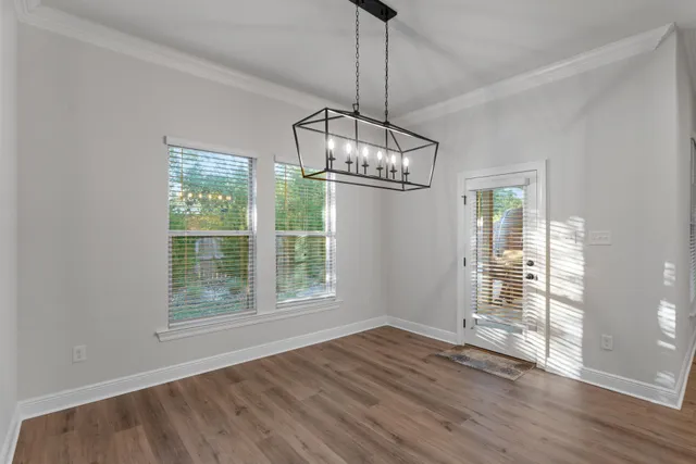 a kitchen with stove and wooden floor